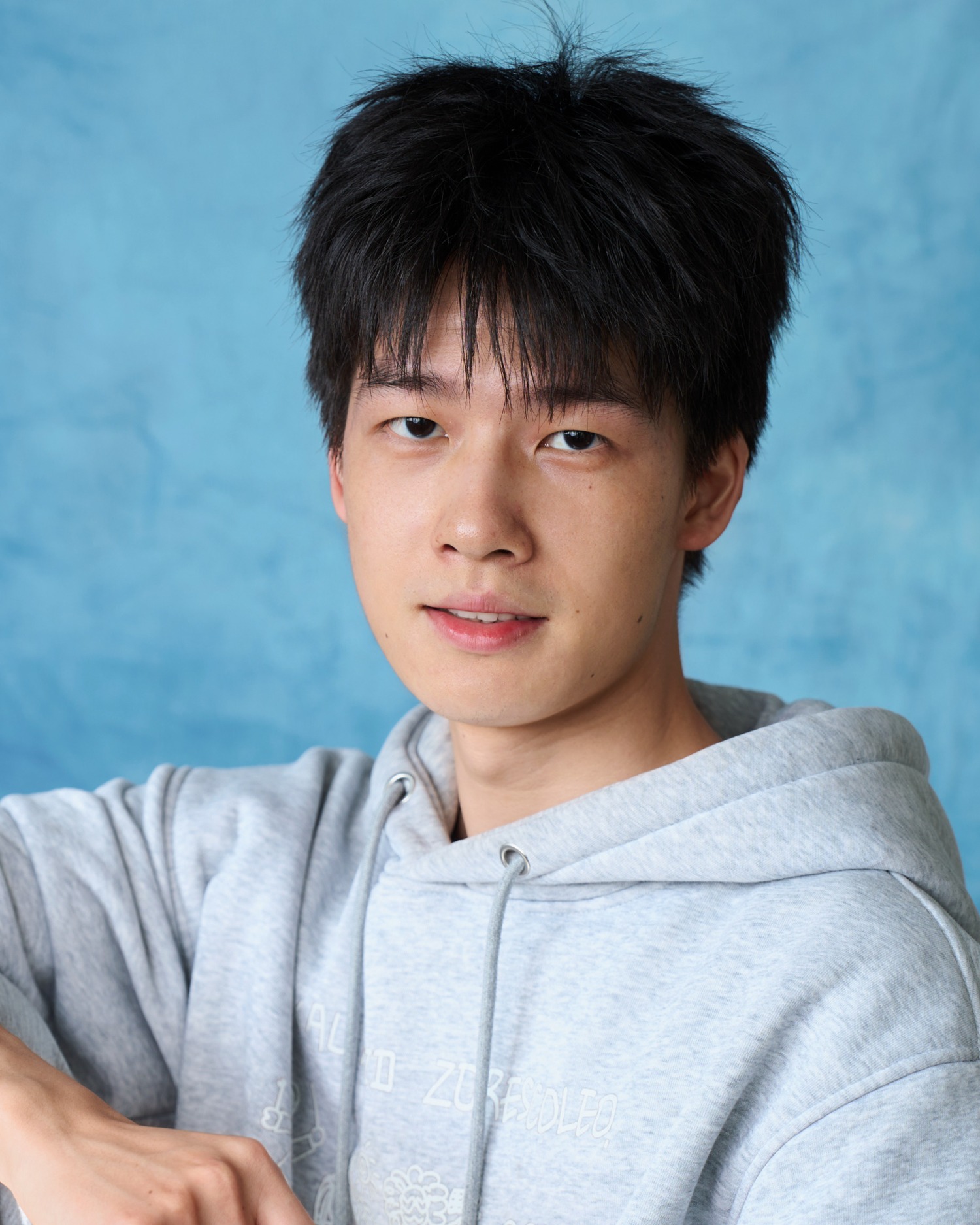 Fred in a grey hoodie, relaxed portrait